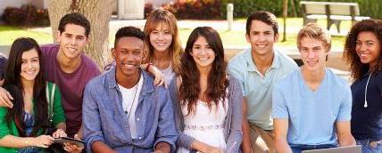 Group of highschool students outside on bench.